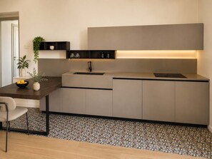 A modern kitchen with a built-in sink, a countertop, and a backsplash. - Penthouse Napoli Terrace-Dante Rooftop (Naples)