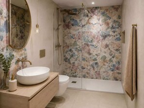 A bathroom with a round sink, toilet, and walk-in shower with floral wall tiles. - Dante Sky Apt: Flowers Room & Terrace (Naples)