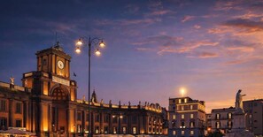 A historic building with a clock tower, street lamps, and classical architecture. - Dante Sky Apt: Flowers Room & Terrace (Naples)