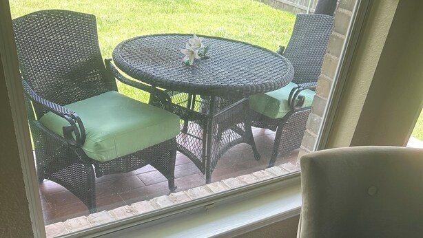 A room with a view of an outdoor patio, a window with blinds, and a partial view of a chair. - Spacious 5-bedroom house in enchanting Austin with AC (Austin)