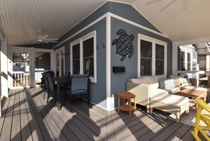 A covered deck with a sofa, chairs, and a table. - NEW Prime Rehoboth Beach Downtown  5BR Coastal Cottage Walk to Beach & Boardwalk (Rehoboth Beach)