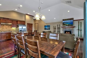 A spacious kitchen with wooden cabinets, a dining table, and chairs. - Ideally Located Condo - 6-min Walk to Casinos (South Lake Tahoe)