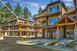 A multi-story residential building with a stone facade, multiple balconies, and a garage entrance. - Ideally Located Condo - 6-min Walk to Casinos (South Lake Tahoe)