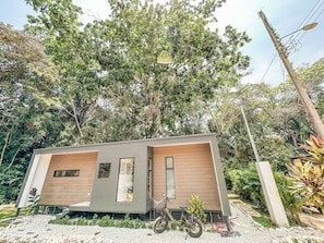 A modern, single-story building with a minimalist design, large windows, and a bicycle parked outside. - Dreamers’ Refuge (adults only, private pool) (Provincia de Puntarenas)