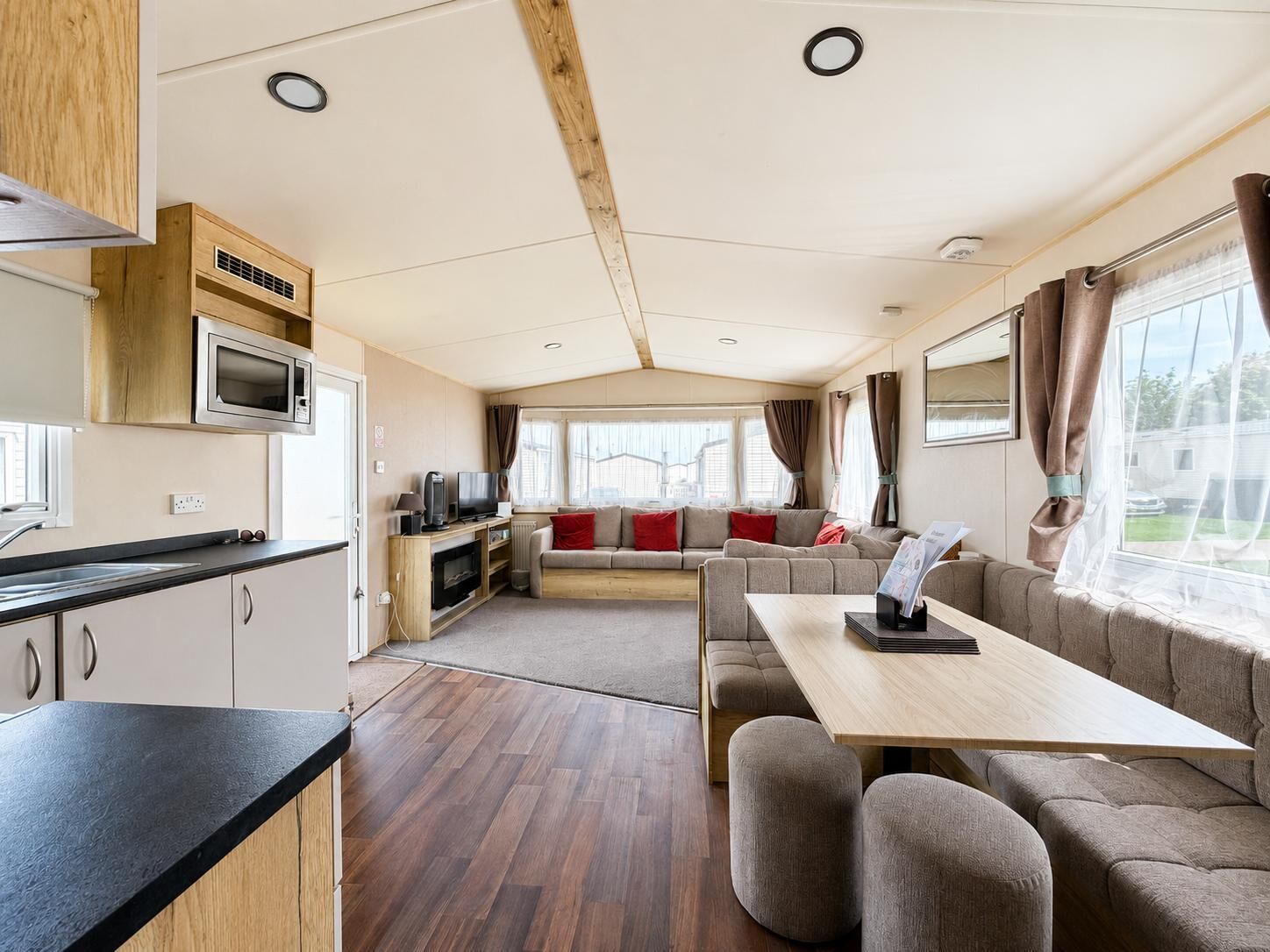 The large open plan lounge with its L shaped sofa is the perfect place to get the family together to discuss the day. They will love being able to plan your next adventure on the coast in Suffolk.