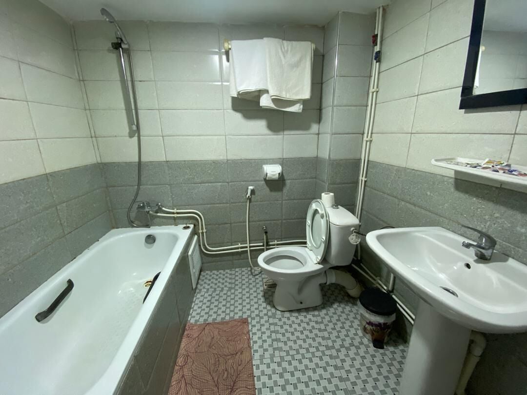 A bathroom with a bathtub, toilet, sink, and shower.