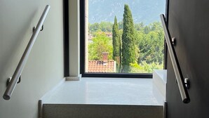 A staircase with a view of a mountain and trees.