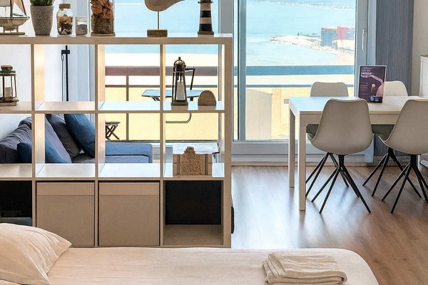 Sunny studio layout with bed and sea view. 🌊