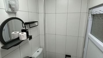 Habitación estándar, para no fumadores | Baño | Regadera, toallas, papel de baño