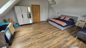 A bedroom with a loft bed, wooden flooring, a wardrobe, and a door. - Villa Near Baltic Sea (2.5 km) – 4 Bedrooms, 3 Bathrooms, Private Garden (Łebcz)