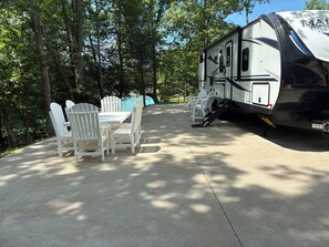 A recreational vehicle with a dining area featuring a table and chairs.