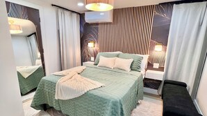 A modern bedroom with a large bed, bedside tables, a bench, a mirror, and a wall-mounted light fixture. - Luxe 3BR with 3 Private Bathrooms Near Airport and 30 mins to NYC (Newark)