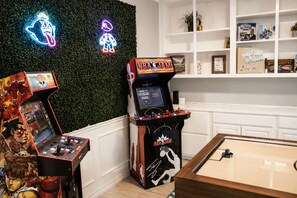 A room with two arcade machines, a pool table, and a wall with neon signs. - Plano Luxury Retreat · Hot Tub · Theater · Game Room Dallas/Frisco Sleeps 8 (Plano)