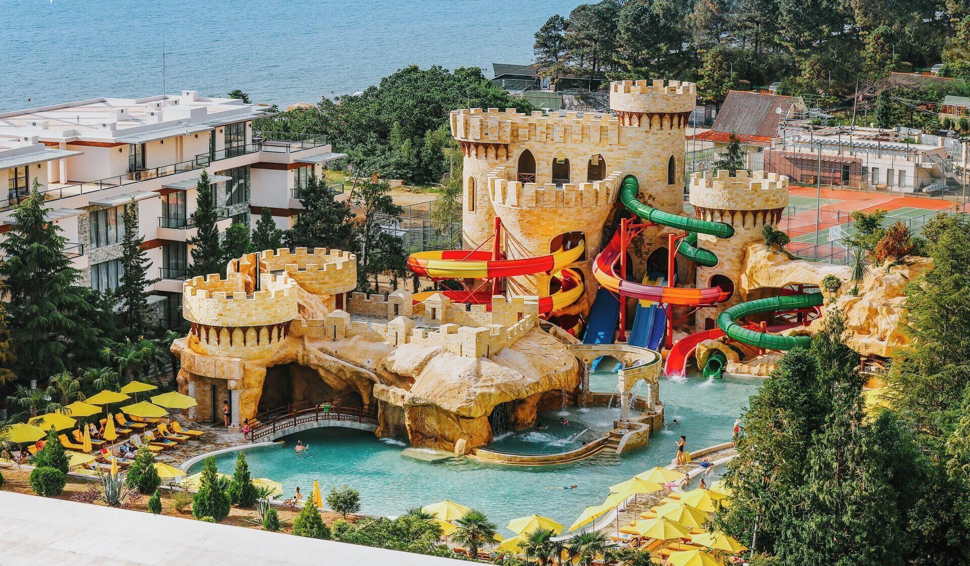 A water park with a castle, slides, and a pool area.