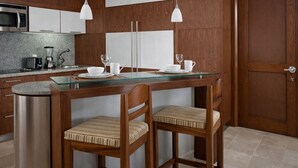 A modern kitchen with a central island, stainless steel appliances, and wooden cabinetry. - Luxury Retreat at The Grand Mayan – Nuevo Nayarit (Nuevo Vallarta)
