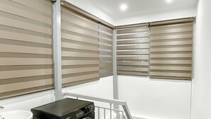 A laundry room with a washing machine, a sink, and a staircase. - Compact Studio w/ Projector & Sky View (Hà Nội)
