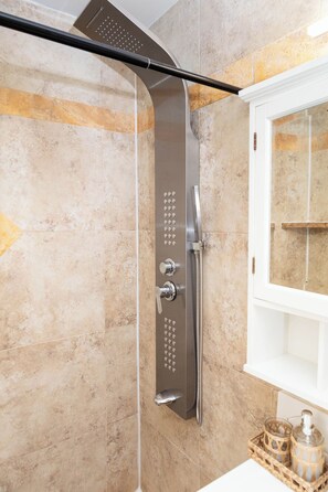 A shower with a curved hose, a control panel, and a white window with a shelf. - The Quads · Private Compound · Pool · Beach · FIFA 2026 · Hard Rock · Sleeps 16+ (Fort Lauderdale)
