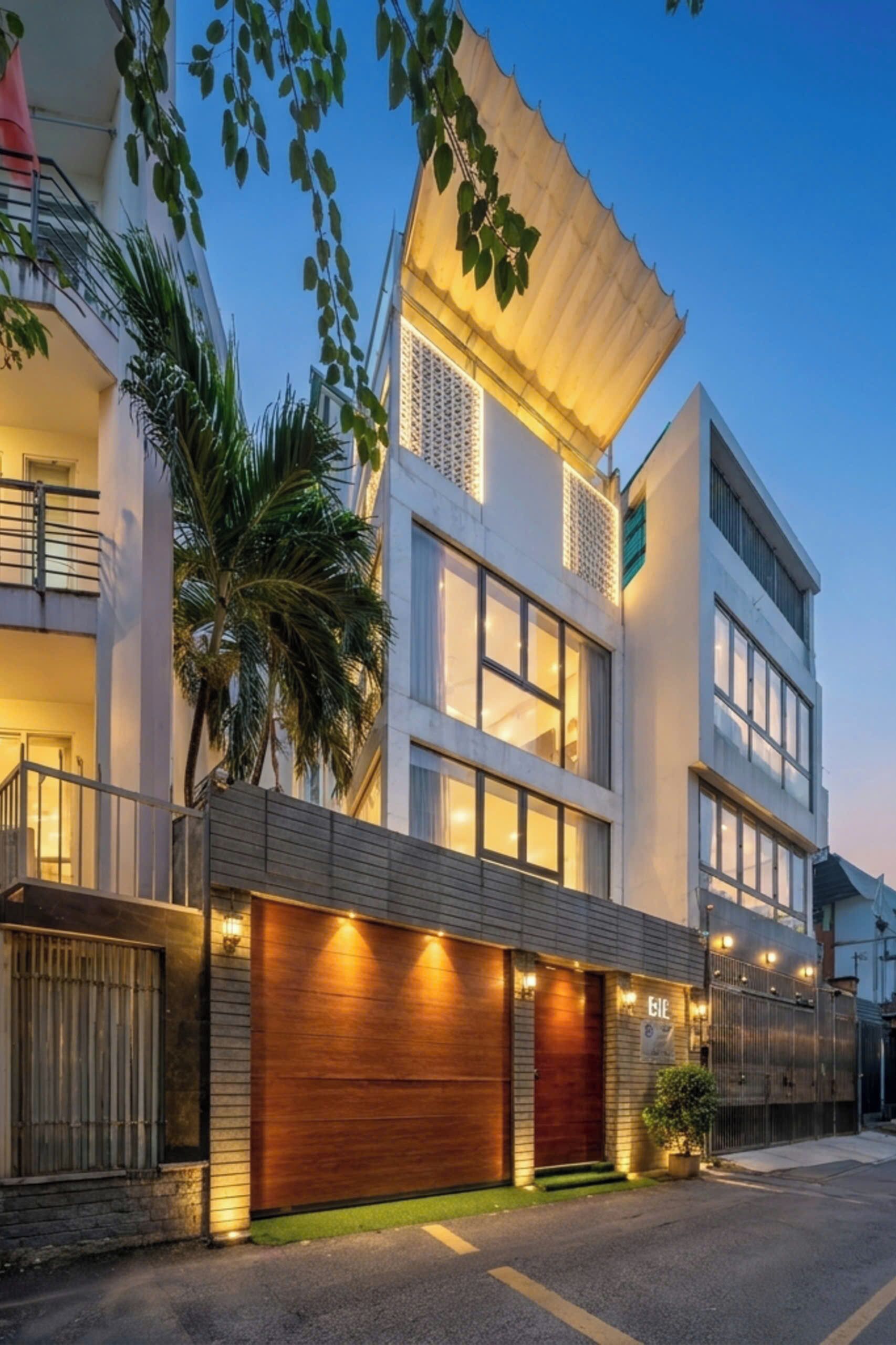 A modern multi-story building with a garage, large windows, and a balcony.