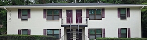 A white building with numbered windows and a central staircase. - Gateway City Getaway (Forest Park)