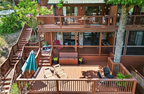 A two-story wooden cabin with a deck, outdoor seating, and a staircase. - LAKE KEOWEE WATERFRONT! ONLY 15 feet from
Shore. Price includes BOAT SLIP (Six Mile)