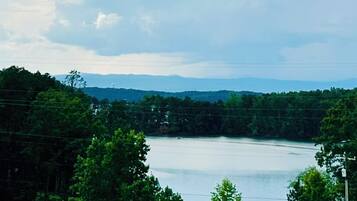 A lake surrounded by trees and hills.