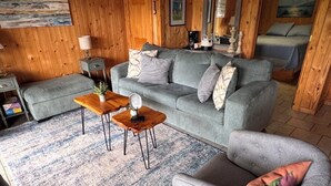 A cozy living room with a grey sofa, a wooden coffee table, and a patterned rug. - LAKE KEOWEE WATERFRONT! ONLY 15 feet from
Shore. Price includes BOAT SLIP (Six Mile)