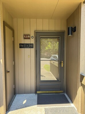 A door with a number sign '119' and a welcome sign above it. - 2Bed2Bath Condo w/ Fairway Views on No. 5: Walk to Club, Cradle & Harness Track (Pinehurst)