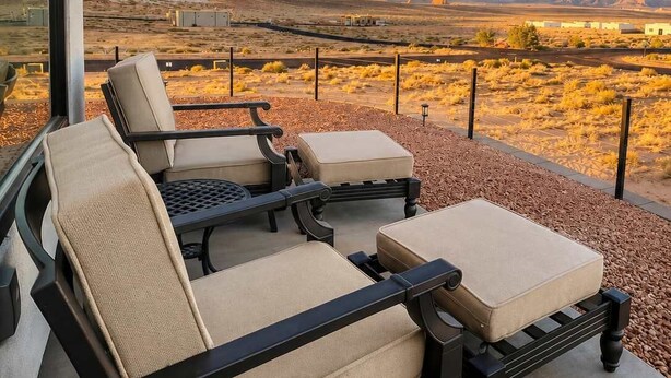 A balcony with outdoor furniture, a clear view of a desert landscape, and a distant mountain range. - The Dark Sky Haven, Luxe Casita, Views, Sleeps 2 (Page)