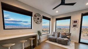 A modern living room with a large window, a ceiling fan, and a sofa. - The Dark Sky Haven, Luxe Casita, Views, Sleeps 2 (Page)