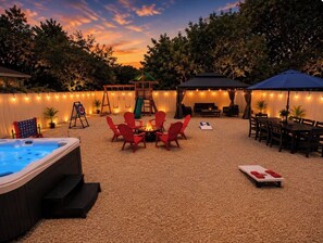 A backyard with a hot tub, fire pit, outdoor seating, and a dining area. - Wilton Manors • Las Olas • Beach • Downtown FTL (Fort Lauderdale)