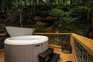 A hot tub with a wooden deck and a metal railing, surrounded by a forested area. - Terrace Creek Retreat | Creekside Hot Tub Escape | 5 Min From Nada Tunnel! (Stanton)