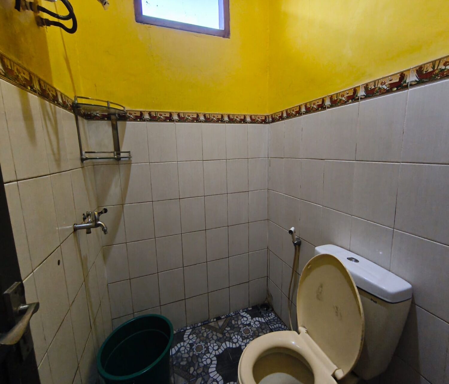 A small bathroom with a toilet, a sink, and a window.