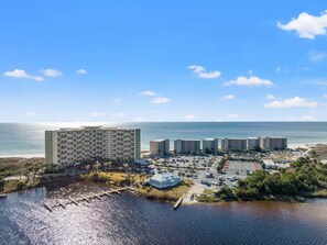Ein Hotel an der Küste mit mehreren Gebäuden, einem Parkplatz und Blick auf das Wasser.