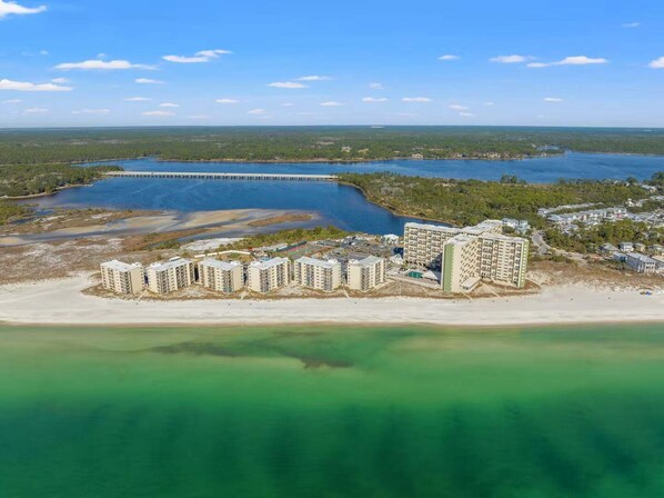 A coastal hotel with multiple buildings, a pier extending into the water, and a beach area. - Pinnacle Peace 707-Gulf Views-Sleeps 4 (Panama City Beach)