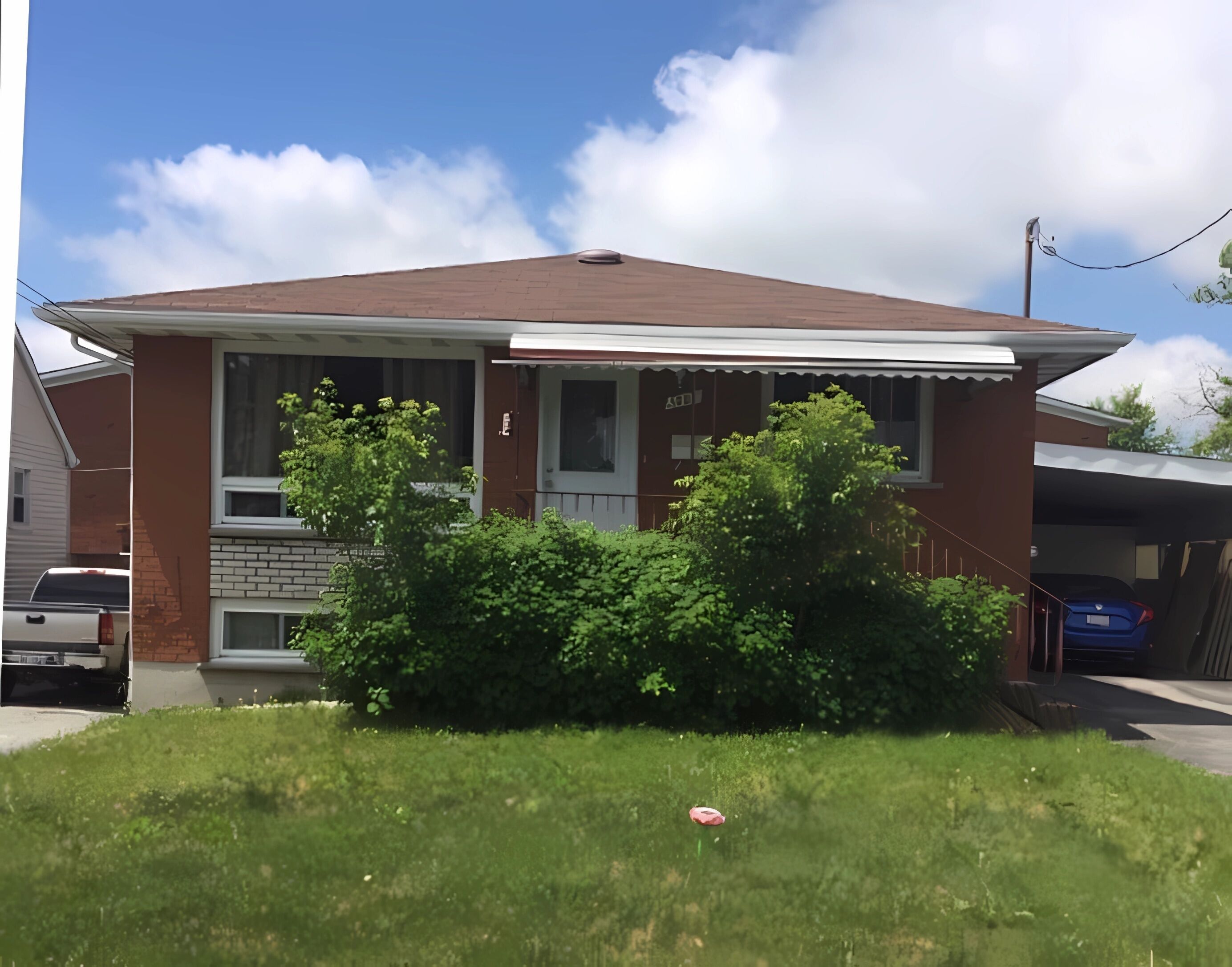 A two-story house with a brick facade, a front porch, and a garage.. Basement Queen Bedroom-C（Private Room，Shared Bathroom）