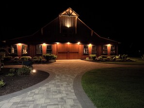 A large, two-story wooden house with a prominent front entrance and a covered porch. - Superb 5 -bedroom Estate in Monroe perfect for family getaways (Monroe)