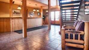 A wooden reception desk, wooden benches, and a tiled floor. - Shoreline Serenity: Ski-In, Beach-Out at Tahoe, Free Parking, Pool and Spa (South Lake Tahoe)