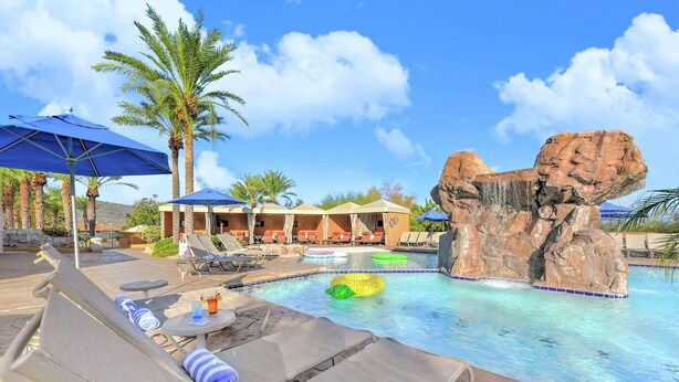 A pool area with lounge chairs, umbrellas, and a rock formation. - 2 Queen Beds 1BR Suite, Hilton Phoenix Tapatio Cliffs, 7 Pools, Spa - 2 Units (Phoenix)