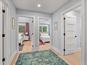 A bedroom with a bed, bedside table, and a window. - Airy & Stylish New Build, 4 Bedrooms, 3.5 Bathrooms, Central to all of Asheville (Asheville)