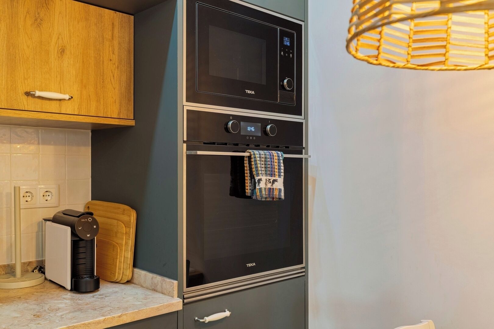 A kitchen with a microwave, oven, and coffee maker.