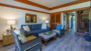 A living room with a sofa, two armchairs, a coffee table, and a ceiling fan. - Aloha Kai | AC | Pool & Hot Tub | Beach Access (Koloa)