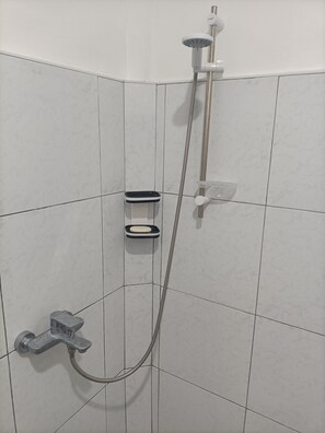 A shower with a handheld showerhead, a handheld shower attachment, and a soap dish. - Studio room Balabagon (Moalboal)