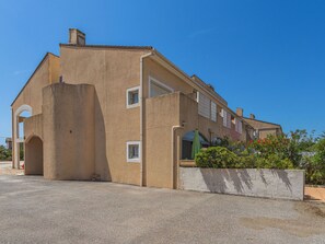 A two-story building with a flat roof, a balcony, and a small garden area. - Les Marines du Levant by Interhome (Hyères)