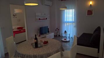 Apartment, Balcony, City View | Living area | Flat-screen TV