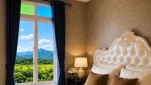 A bedroom with a large bed, a nightstand with a lamp, and a view of a green landscape through a window. - Banana Village Resort (Mae Taeng)