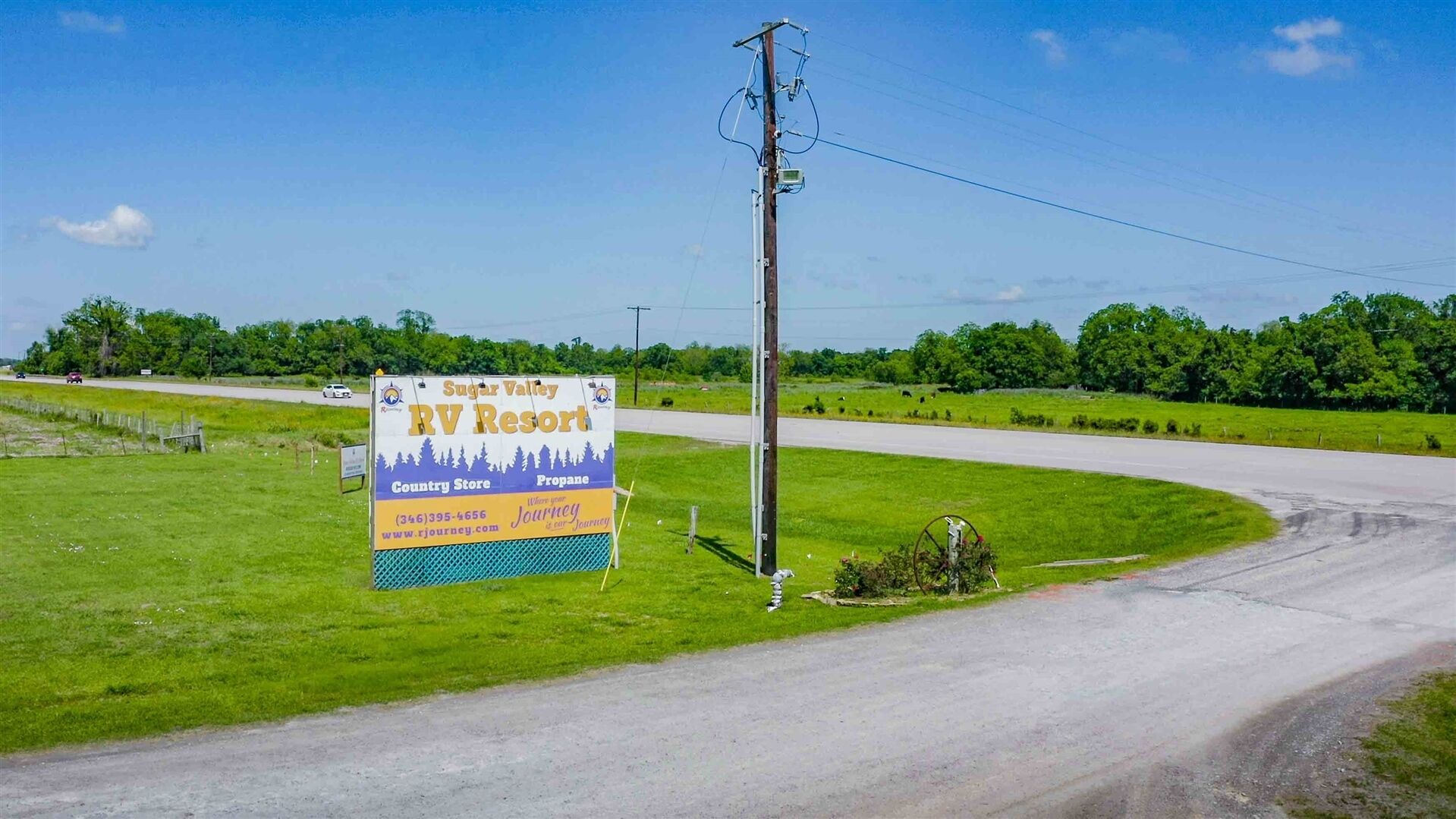 A roadside sign for Sugar Valley RV Resort with a country store and propane service.