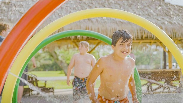 A water play area with a thatched roof structure. - Sugar Valley RV Resort (Van Vleck)