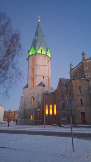 A historic building with a prominent tower and arched windows. - Narva Promenade (Narva)