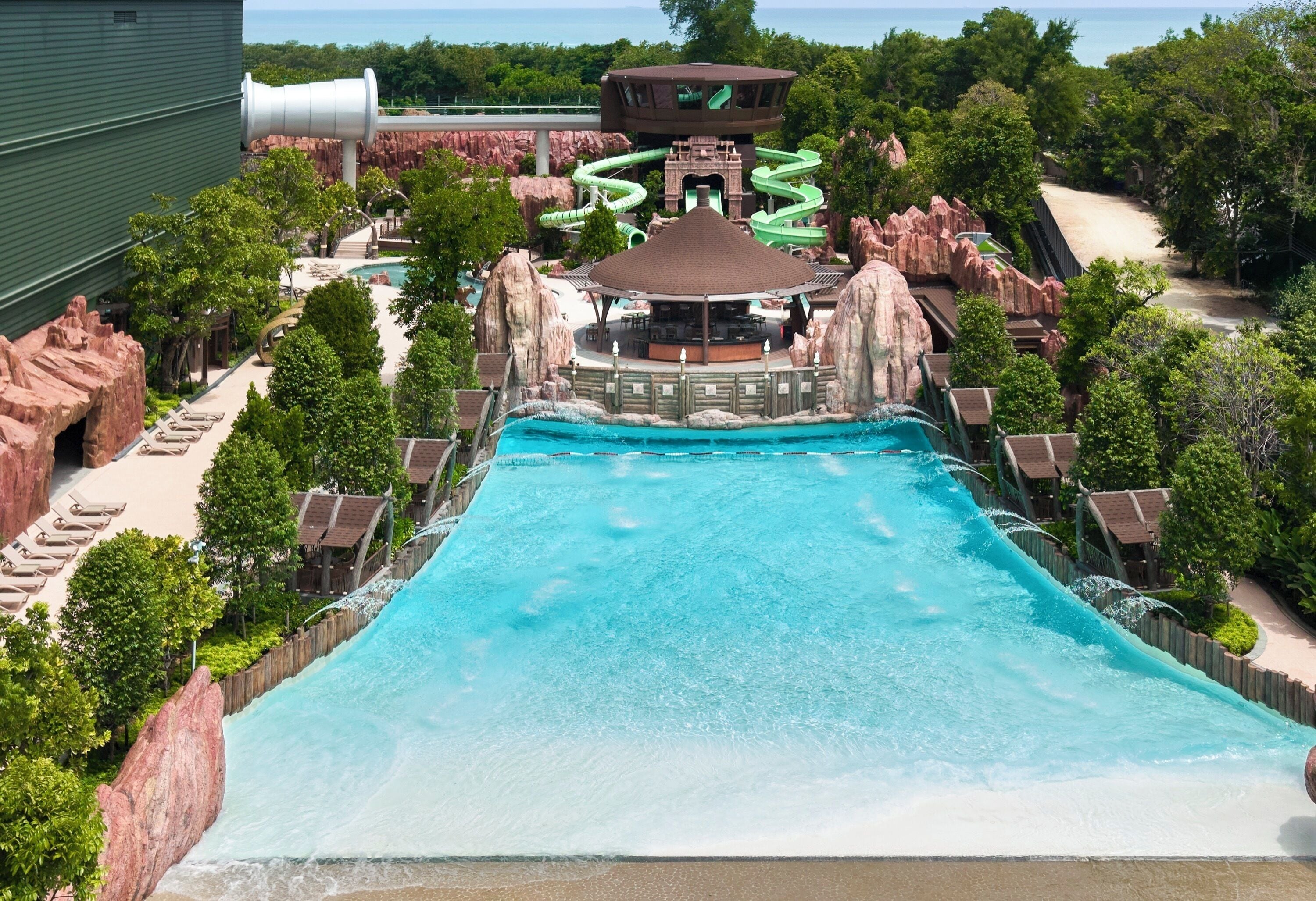 A water park with a large pool, slides, and a viewing platform.