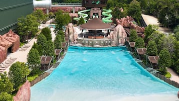 A water park with a large pool, slides, and a viewing platform.